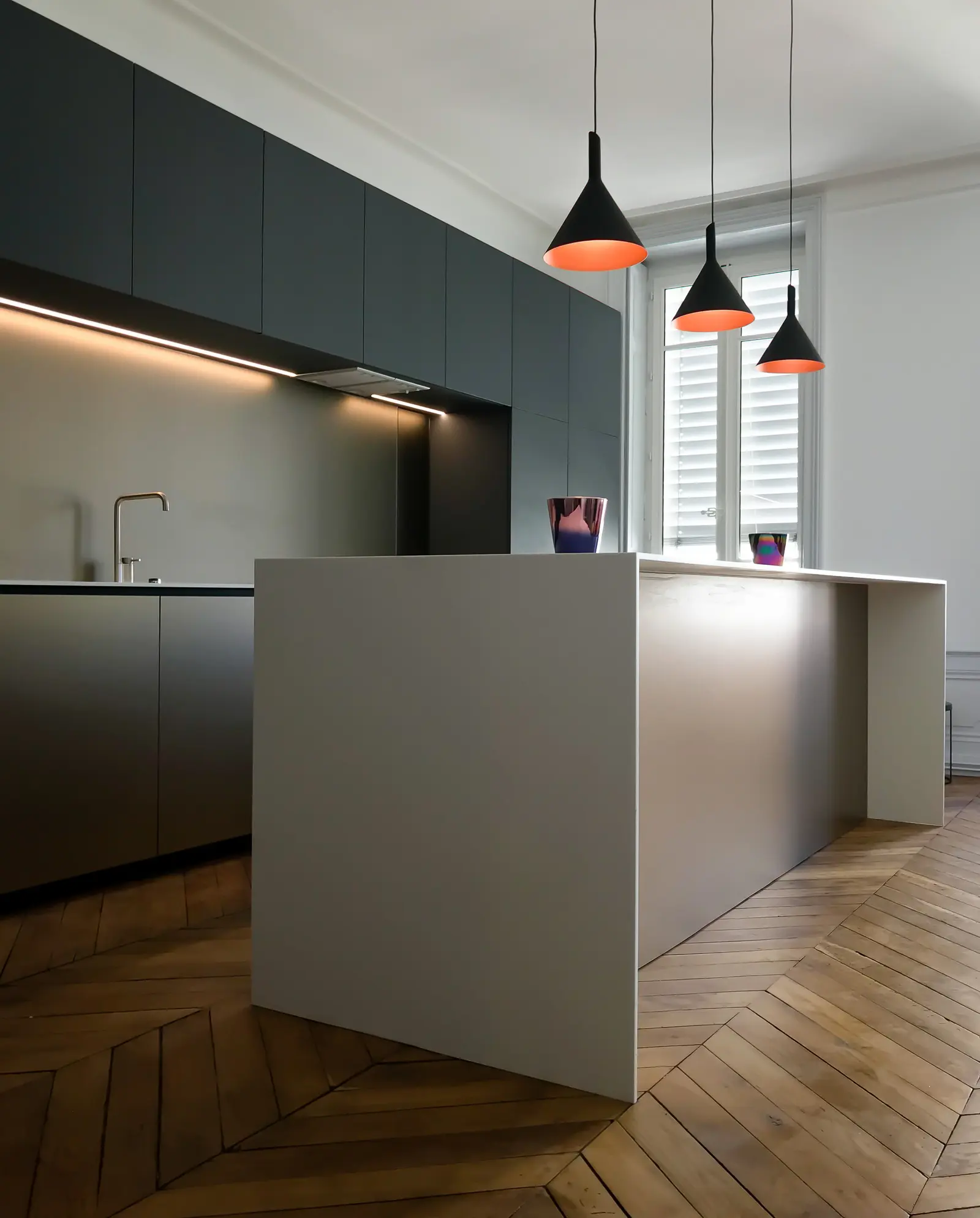 Contraste entre cuisine épurée et parquet chevron d'origine, presqu'île de Lyon