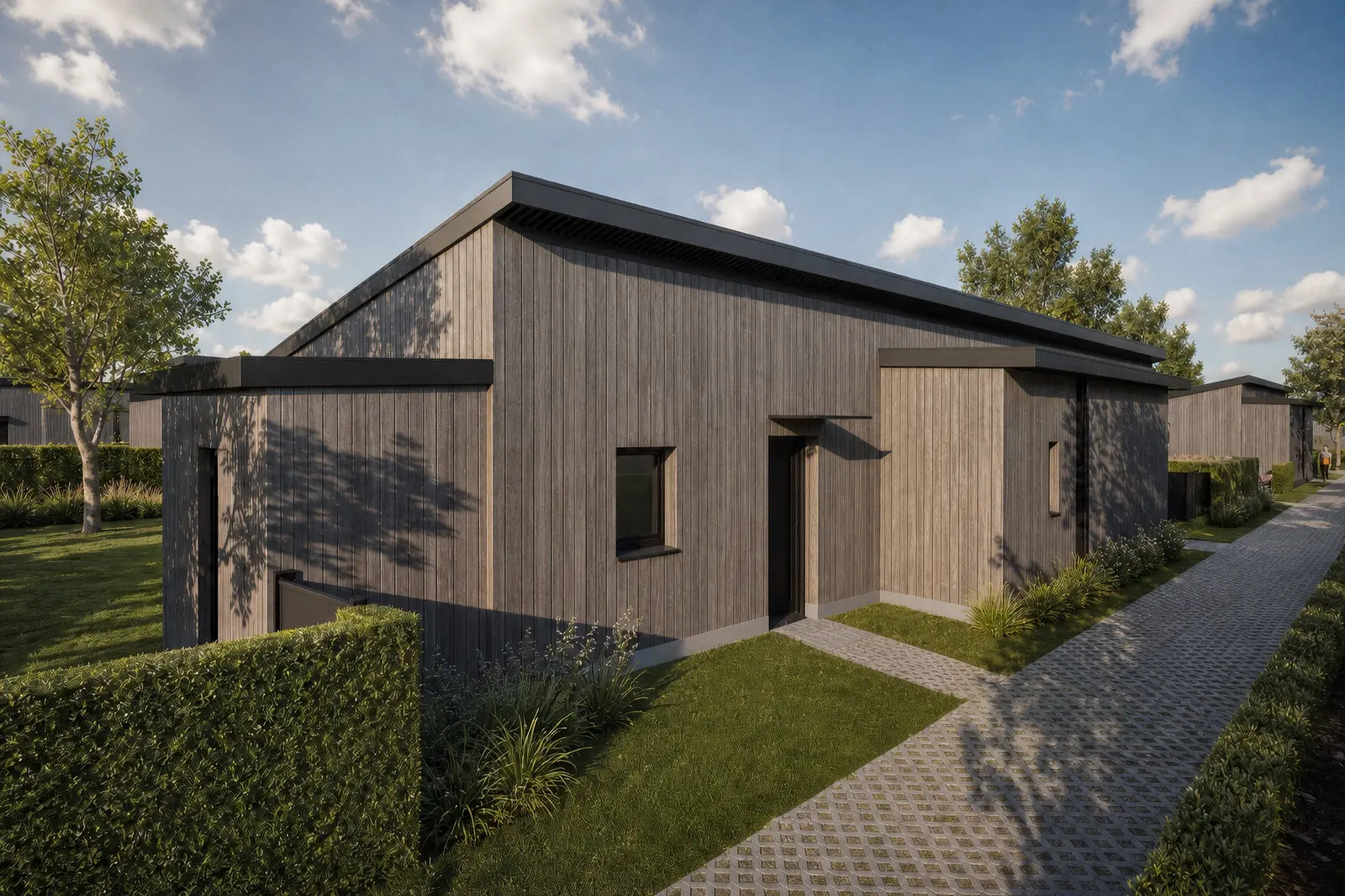 Entrée d'une maison passive de Bletterans, bardage bois et venelle pavée drainante